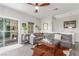 Comfortable living room featuring a large sectional sofa, stylish decor, and access to a patio at 3845 Wiggins Bay St # 202, Las Vegas, NV 89129