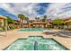Community pool and spa area with lounge chairs and umbrellas in a well maintained outdoor setting at 3845 Wiggins Bay St # 202, Las Vegas, NV 89129