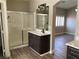 Bathroom with a large shower, modern fixtures, dark cabinets, and decorative mirror at 3882 Genoa Dr, Las Vegas, NV 89141