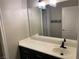 Neutral bathroom vanity with dark cabinets, bright lighting, and a large mirror at 3882 Genoa Dr, Las Vegas, NV 89141
