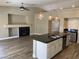 Open concept kitchen and living space with fireplace, granite countertops and stainless steel appliances at 3882 Genoa Dr, Las Vegas, NV 89141