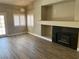 Spacious living room with wood flooring, a fireplace, and glass doors leading to the backyard at 3882 Genoa Dr, Las Vegas, NV 89141