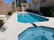 Backyard oasis featuring a sparkling pool, a relaxing spa, and a well-maintained patio area at 3882 Genoa Dr, Las Vegas, NV 89141