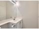 Bathroom featuring a large mirror over a vanity with storage, with white cabinets and a neutral countertop at 427 Rhythm St, Henderson, NV 89074