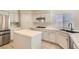 Bright kitchen with white cabinets, stainless steel appliances, and tile countertops, blending style and functionality at 427 Rhythm St, Henderson, NV 89074