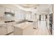 Open-concept kitchen with white cabinets, a central island, and stainless steel appliances, perfect for entertaining at 427 Rhythm St, Henderson, NV 89074