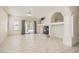 Spacious living room with tile floors, fireplace, ceiling fan, and access to the backyard through sliding glass doors at 427 Rhythm St, Henderson, NV 89074