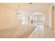 Expansive living room with neutral tones, arched doorways, and abundant natural light, perfect for relaxation and gatherings at 427 Rhythm St, Henderson, NV 89074