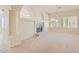 Bright living room with a fireplace, plush carpet, decorative lighting, and arched entryway at 427 Rhythm St, Henderson, NV 89074