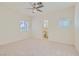 Spacious main bedroom with ceiling fan, neutral carpet, and natural light at 427 Rhythm St, Henderson, NV 89074