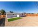 Private backyard featuring artificial turf, a concrete patio, and a new wood fence at 4360 El Tovar Rd, Las Vegas, NV 89115