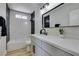 Modern bathroom with stylish vanity, mirror, and tiled shower at 4360 El Tovar Rd, Las Vegas, NV 89115