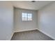 Bedroom with window, gray carpet and white walls at 4360 El Tovar Rd, Las Vegas, NV 89115