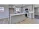The modern kitchen features quartz countertops, grey cabinets and an open floorplan at 4360 El Tovar Rd, Las Vegas, NV 89115