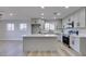 Modern kitchen features sleek gray cabinets, stainless steel appliances, and quartz countertops with an island at 4360 El Tovar Rd, Las Vegas, NV 89115