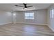 Spacious living room with wood flooring, a ceiling fan, and ample natural light at 4360 El Tovar Rd, Las Vegas, NV 89115