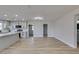 Spacious living room with light wood flooring and modern light fixtures plus a remodeled kitchen at 4360 El Tovar Rd, Las Vegas, NV 89115