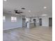 Spacious living room with natural light, wood floors, and an open layout to the modern kitchen at 4360 El Tovar Rd, Las Vegas, NV 89115