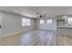 Open layout with wood flooring, a ceiling fan, and natural light with an adjacent kitchen at 4360 El Tovar Rd, Las Vegas, NV 89115