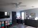 Bedroom with a ceiling fan, grey walls, wood floors, and a view of the outside at 4361 Duck Harbor Ave, North Las Vegas, NV 89031