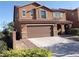 Two-story home with a two-car garage and a low maintenance landscaped front yard at 4361 Duck Harbor Ave, North Las Vegas, NV 89031
