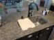 Granite counters complement this kitchen with undermount sink and modern faucet fixture at 4361 Duck Harbor Ave, North Las Vegas, NV 89031