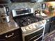 Gourmet kitchen featuring stainless steel gas range and granite countertops at 4361 Duck Harbor Ave, North Las Vegas, NV 89031