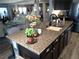 Stylish kitchen island with granite countertops, sink, and seating area with open floorplan at 4361 Duck Harbor Ave, North Las Vegas, NV 89031