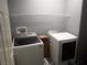 Functional laundry room with modern washer and dryer, and shelf at 4361 Duck Harbor Ave, North Las Vegas, NV 89031