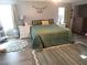 Spacious main bedroom features a green quilt, wood floors, and ample natural light at 4361 Duck Harbor Ave, North Las Vegas, NV 89031