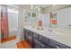 Bright bathroom with double sinks, modern fixtures, and a shower-tub combo at 4465 Shimmering Skies St # 1177, North Las Vegas, NV 89031