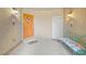 Cozy entryway featuring a bright front door, welcome mats, and a decorative bench at 4465 Shimmering Skies St # 1177, North Las Vegas, NV 89031