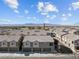 Townhome exteriors boast modern architecture and neutral color palettes, with mountain views in distance at 4465 Shimmering Skies St # 1177, North Las Vegas, NV 89031