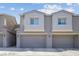 Close up of townhome exterior with attached garages in a neutral color palette at 4465 Shimmering Skies St # 1177, North Las Vegas, NV 89031