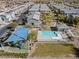 Aerial view of community pool and playground area with shade structure, and nearby townhomes at 4465 Shimmering Skies St # 1177, North Las Vegas, NV 89031