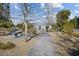 Stone walkway featuring stone benches and BBQ grills, surrounded by mature trees and desert landscaping at 4465 Shimmering Skies St # 1177, North Las Vegas, NV 89031
