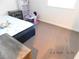 Bedroom with neutral carpet and view of play area, bed and nightstand at 4663 Sand Creek Ave, Las Vegas, NV 89103