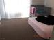 Comfortable bedroom with carpet, a crib, and a bed by the window for a serene space at 4663 Sand Creek Ave, Las Vegas, NV 89103