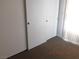 Bedroom with white closet doors, tan carpet, and neutral wall color at 4663 Sand Creek Ave, Las Vegas, NV 89103