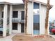 Exterior facade of the building with black wrought iron doors and stairs at 4663 Sand Creek Ave, Las Vegas, NV 89103