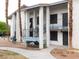 Two-story apartment building showcasing supported columns, desert landscaping, and a stairway to upper level units at 4663 Sand Creek Ave, Las Vegas, NV 89103