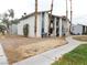 Two-story apartment complex featuring stucco facade, supported columns, and desert landscaping in an arid climate at 4663 Sand Creek Ave, Las Vegas, NV 89103