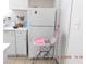 Clean kitchen with appliances and a refrigerator, alongside a high chair for Gathering convenience at 4663 Sand Creek Ave, Las Vegas, NV 89103