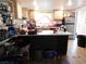 Modest kitchen with island, light cabinetry, and an array of countertop appliances at 4663 Sand Creek Ave, Las Vegas, NV 89103