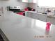 Bright kitchen features long countertop and white cabinetry creating a clean, modern aesthetic at 4663 Sand Creek Ave, Las Vegas, NV 89103