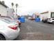 Community parking lot with vehicle and covered trash containers at 4663 Sand Creek Ave, Las Vegas, NV 89103