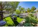 Inviting backyard with lush green artificial turf, lounge furniture, and a relaxing hot tub for outdoor enjoyment at 504 Painted Cloud Pl, Las Vegas, NV 89144