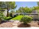 Inviting backyard with lush green artificial turf, lounge furniture, and a relaxing hot tub for outdoor enjoyment at 504 Painted Cloud Pl, Las Vegas, NV 89144