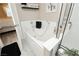 Bright bathroom features a soaking tub, white tile surround, and stylish decor; bedroom is partially seen at 504 Painted Cloud Pl, Las Vegas, NV 89144