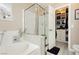 Well-organized bathroom with a bathtub, glass-enclosed shower, and a neatly arranged walk-in closet for optimal storage at 504 Painted Cloud Pl, Las Vegas, NV 89144